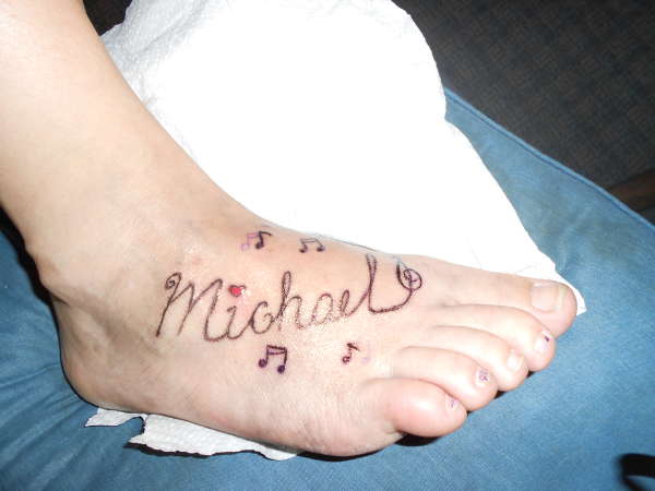 Michael with music notes tattoo