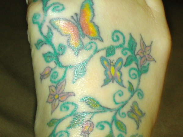 butterflies on foot tattoo