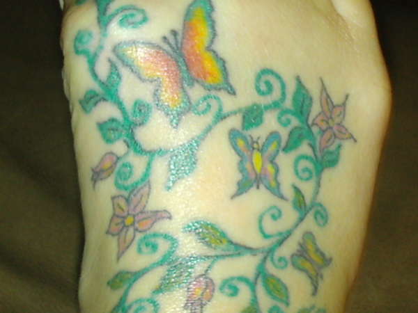 butterflies on foot tattoo