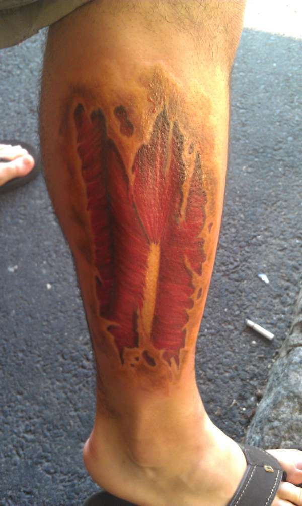 muscle rip leg tattoo