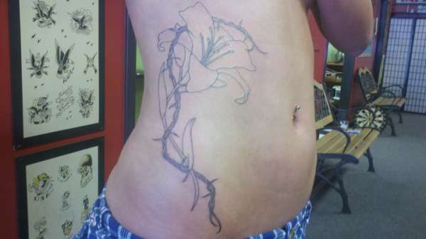 Lilly Wrapped in Barbed Wire tattoo