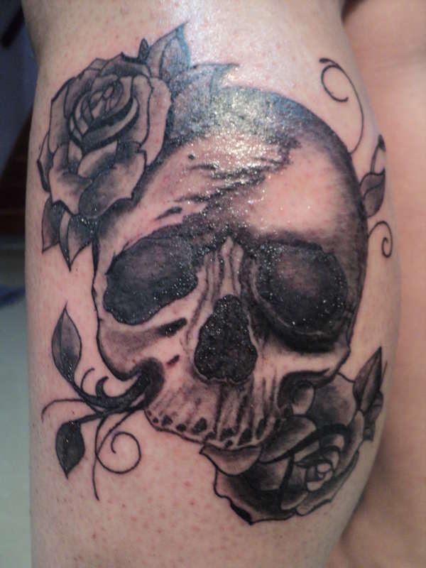 Skull and flowers tattoo