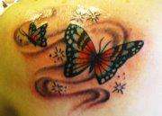 butterflies and swirls tattoo