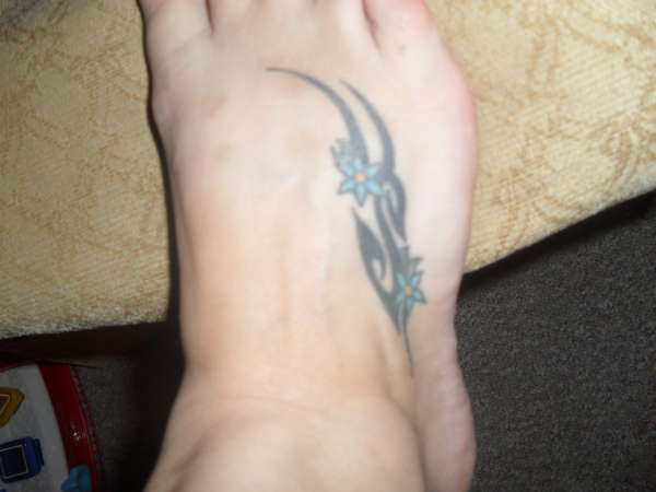 tribal and flowers on foot tattoo