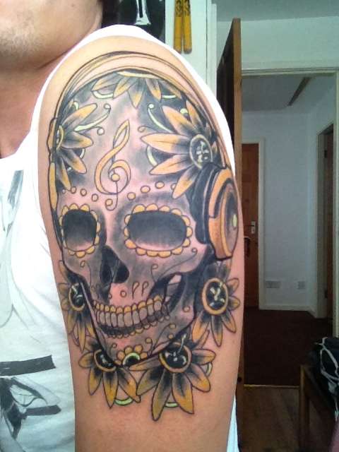 candy skull with headphones tattoo