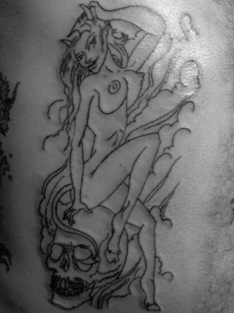 devil girl on a guys ribs tattoo