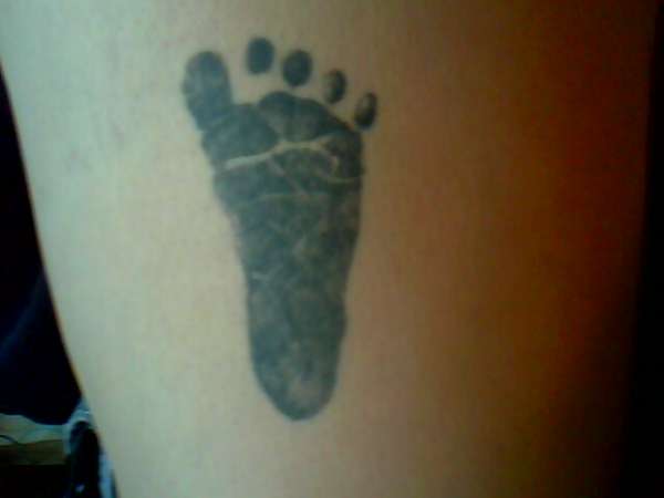 Footprint on thigh tattoo