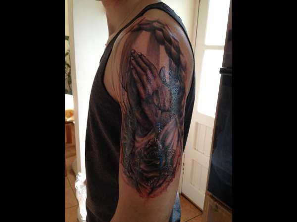 Prayer hands with roses tattoo