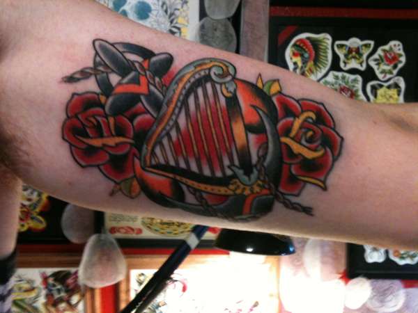 Traditional harp and anchor tattoo