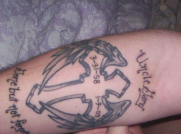 cross with angel wings and text tattoo