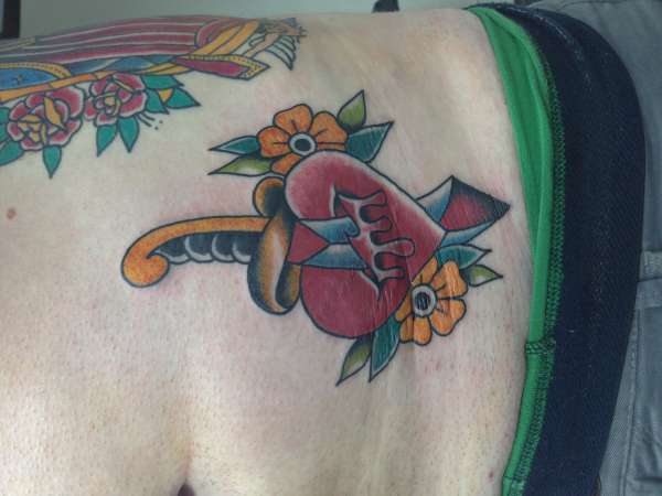 Heart and dagger on stomach tattoo