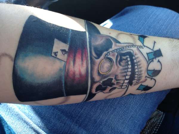 Skull and top hat tattoo