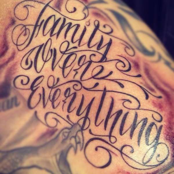 Family over everything freehand script tattoo