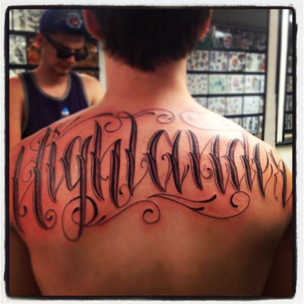 Freehand back tattoo lettering last name tattoo
