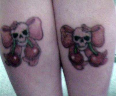 Skull Bows with cherry's on calfs tattoo