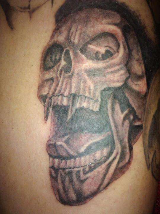 A screaming skull. tattoo