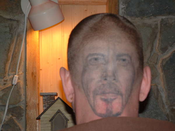 face on head tattoo
