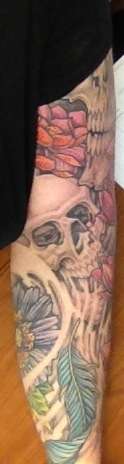Skull inner arm tattoo