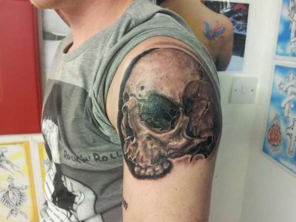 Skull piece tattoo