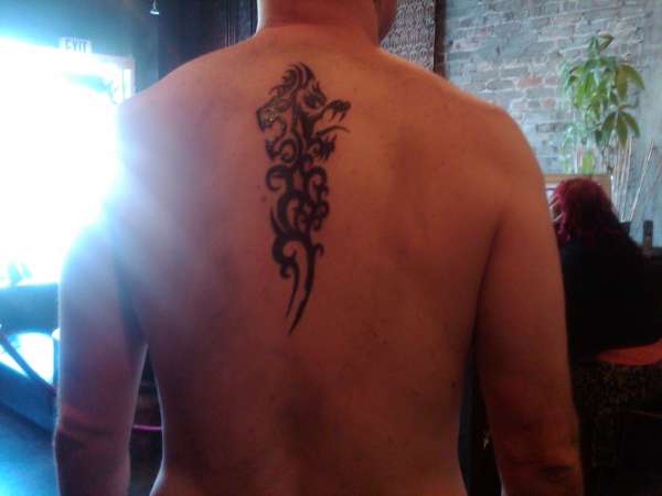 Dragon/Lion with tribal Koru tattoo