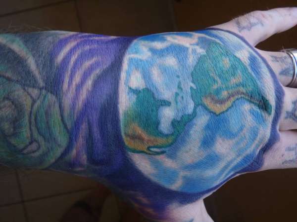 Earth on hand tattoo