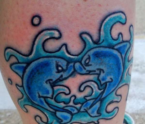 Kissing dolphins tattoo