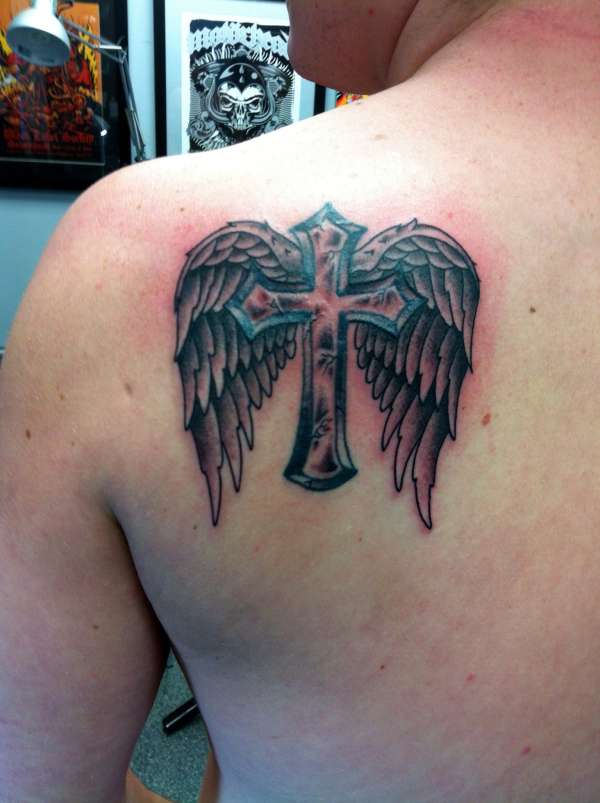 Wings and cross tattoo