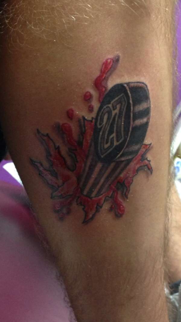 Hockey puck tattoo