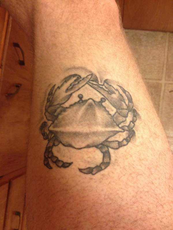 Crab crawling on skin tattoo