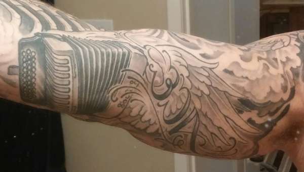 winged accordian tattoo