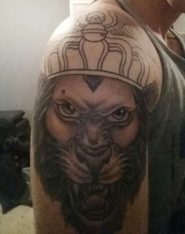 Roaring lion with crown tattoo