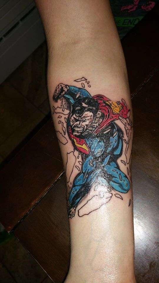 Superman throught arm tattoo