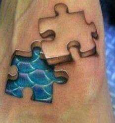 3D jigsaw pieces on foot tattoo