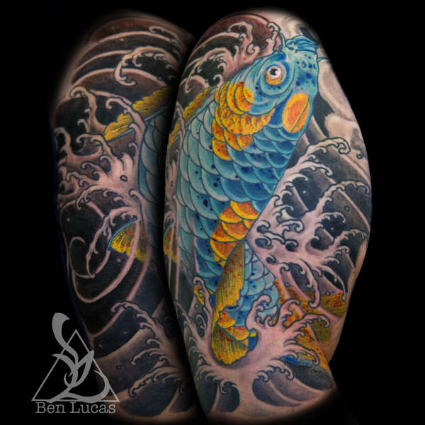 Blue and Gold koi fish swimming up and jumping out of fingerwave tattoo