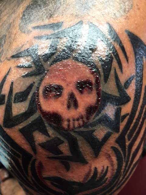 Skull tribal sun tattoo