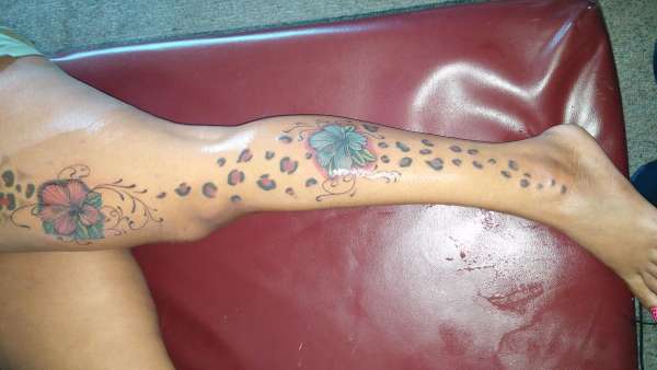 flower tatt with cheetah prints tattoo