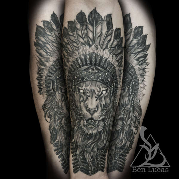 Brandons-lion-with-indian-headdress-in-black-and-grey-inner-fore tattoo