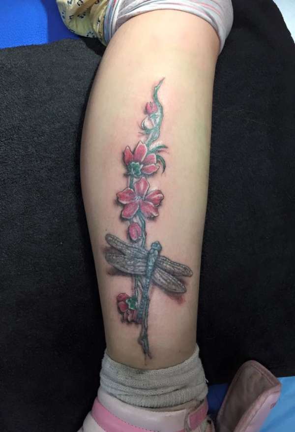 Flower and firefly tattoo