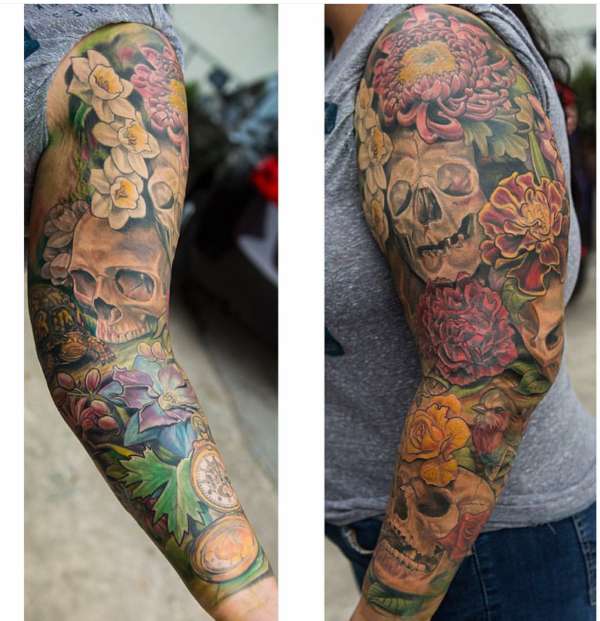 Skulls and flowers sleeve tattoo