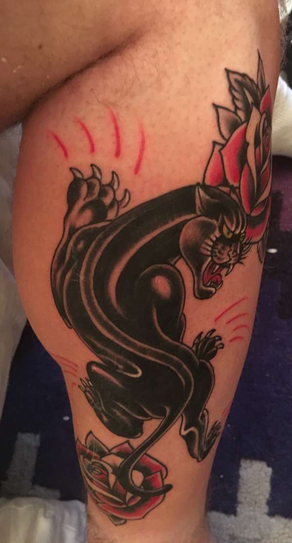 Climbing panther with roses tattoo