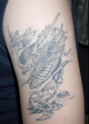 Emerging dragon tattoo