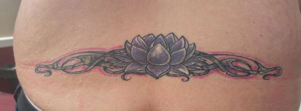 Lower back coverup tattoo