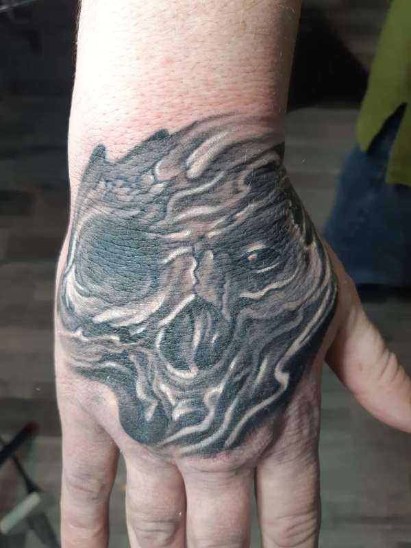 Skull on hand tattoo