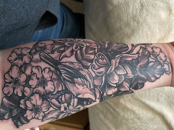 Black and grey flowers and chickadee. tattoo