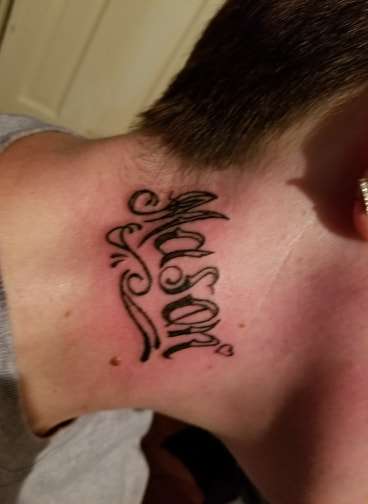 sons name on her neck Mason by santa clause tattoo