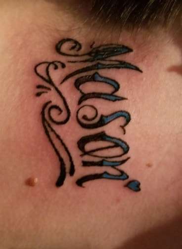 sons name on her neck Mason by santa clause tattoo