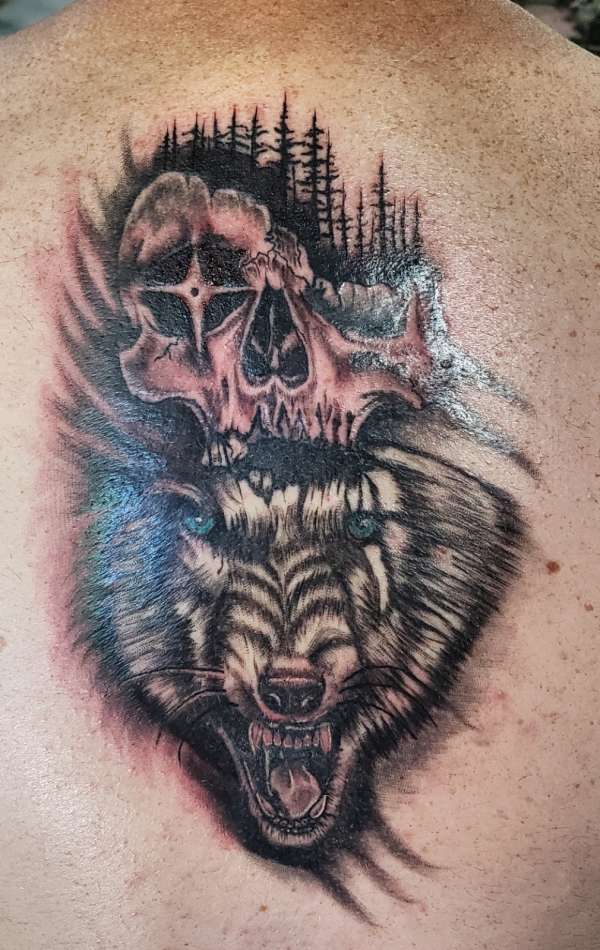 Lone skull and wolf tattoo