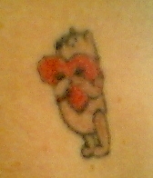 Winnie hugging heart tattoo