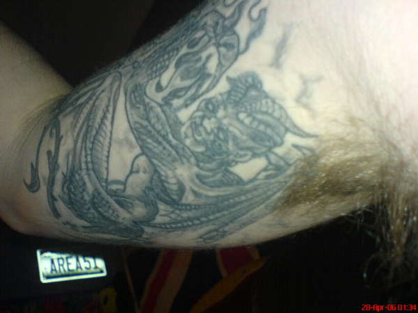 demon holding fire tattoo
