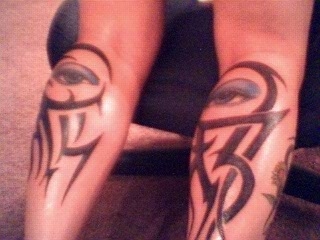tribal and eyes tattoo